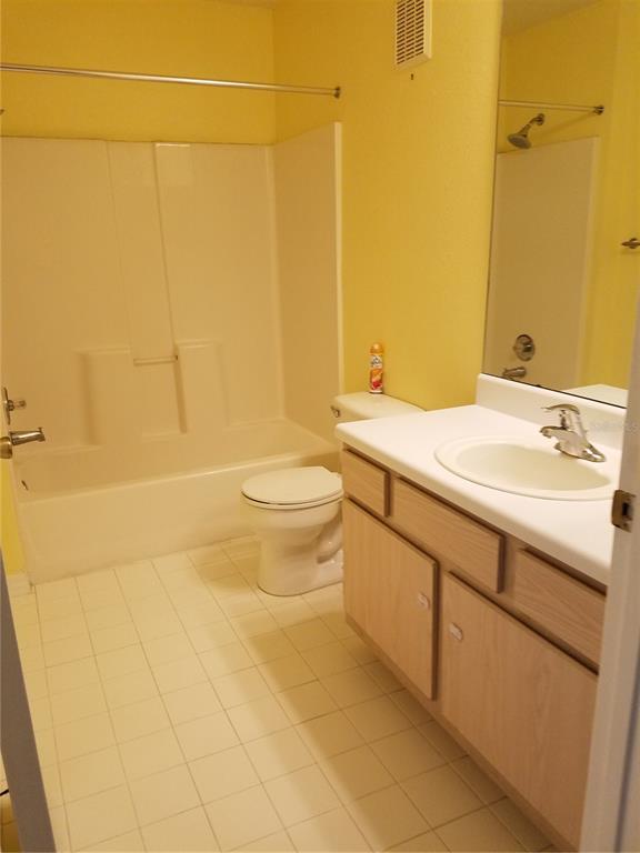 5455 Vineland Road, Unit 3303 Orlando, FL 32811 - Photo 6 of 8 a bathroom with a sink a toilet and shower