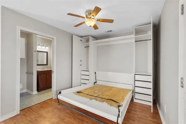 a bedroom with a bed and a ceiling fan