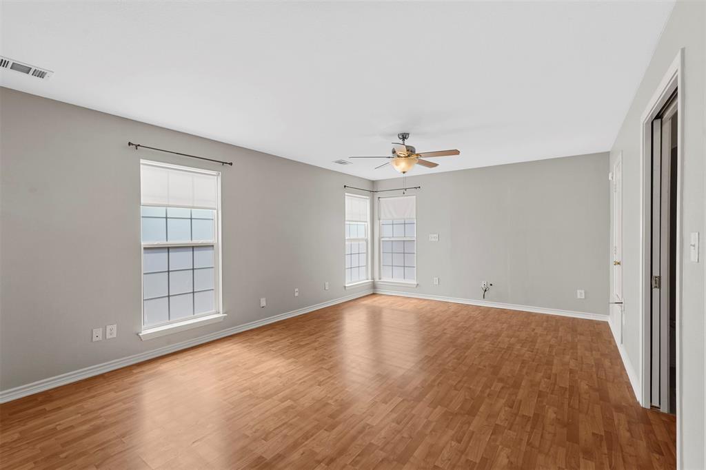 20602 Hackberry Creek Park Road Frisco, TX 75036 - Photo 7 of 20 wooden floor in an empty room with a window