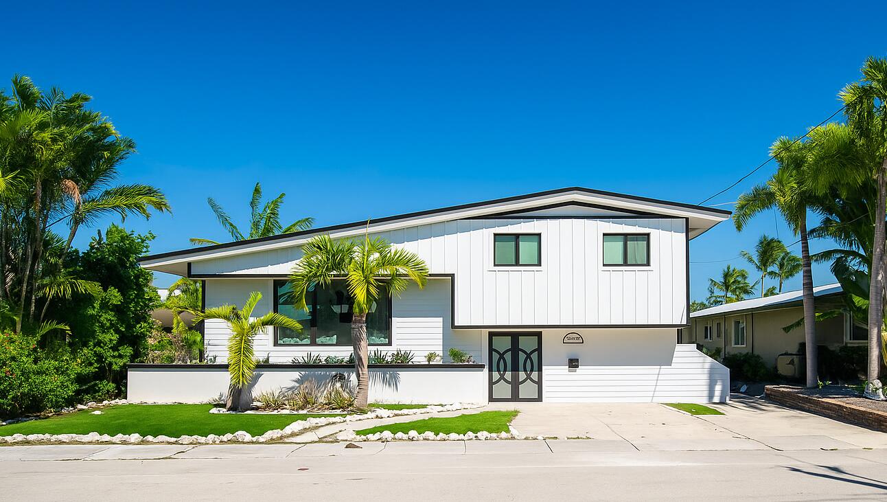 a front view of a house with a garden and porch