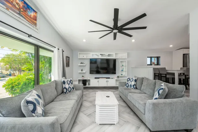 a kitchen with kitchen island granite countertop a sink stainless steel appliances and cabinets