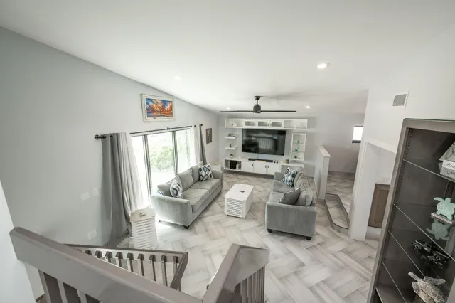 a view of a house with a swimming pool and a chairs