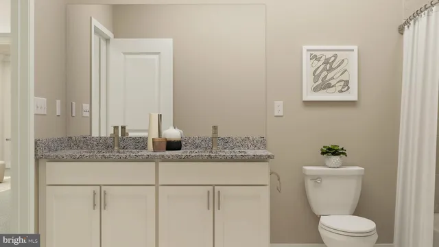 a bathroom with a granite countertop sink a toilet and mirror