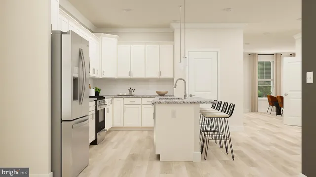 a kitchen with a refrigerator and white cabinets