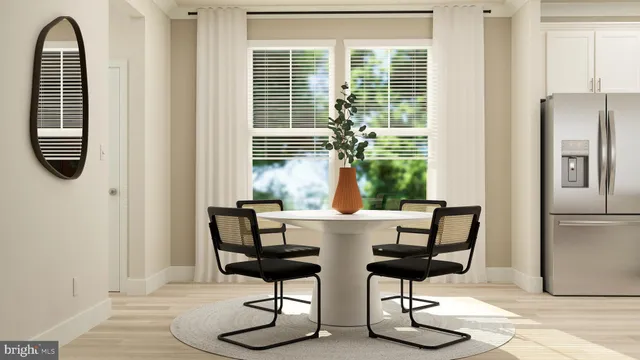 a view of a dining room with furniture window and wooden floor