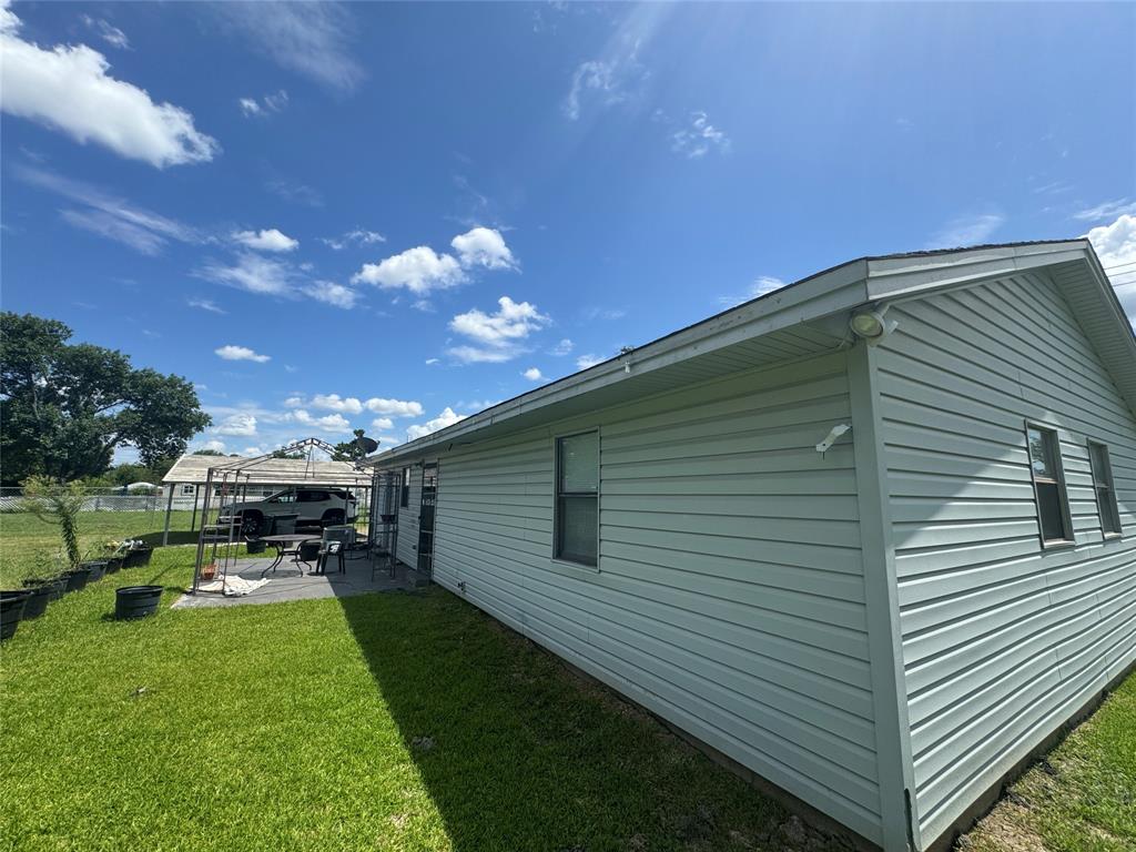 207 College Mound Road Terrell, TX 75160 - Photo 7 of 14 Light-colored siding exterior featuring multiple windows and a pitched roofline