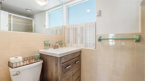 a bathroom with a sink a mirror and a bathtub