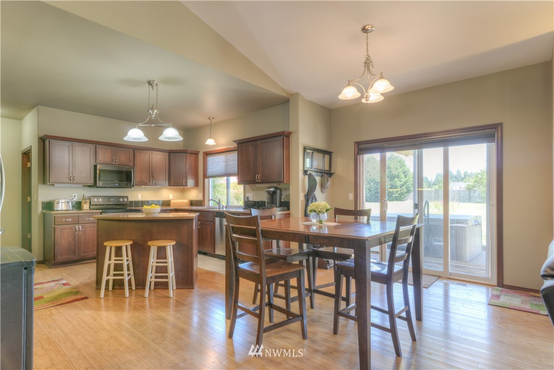 8422 180th Way Southwest Rochester, WA 98579 - Photo 11 of 34 a view of a dining room with furniture window and wooden floor