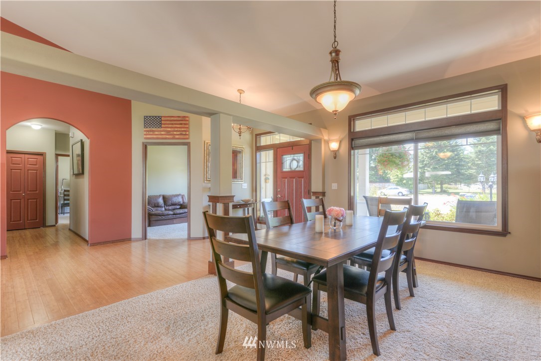 8422 180th Way Southwest Rochester, WA 98579 - Photo 21 of 34 a view of a dining room with furniture window and wooden floor