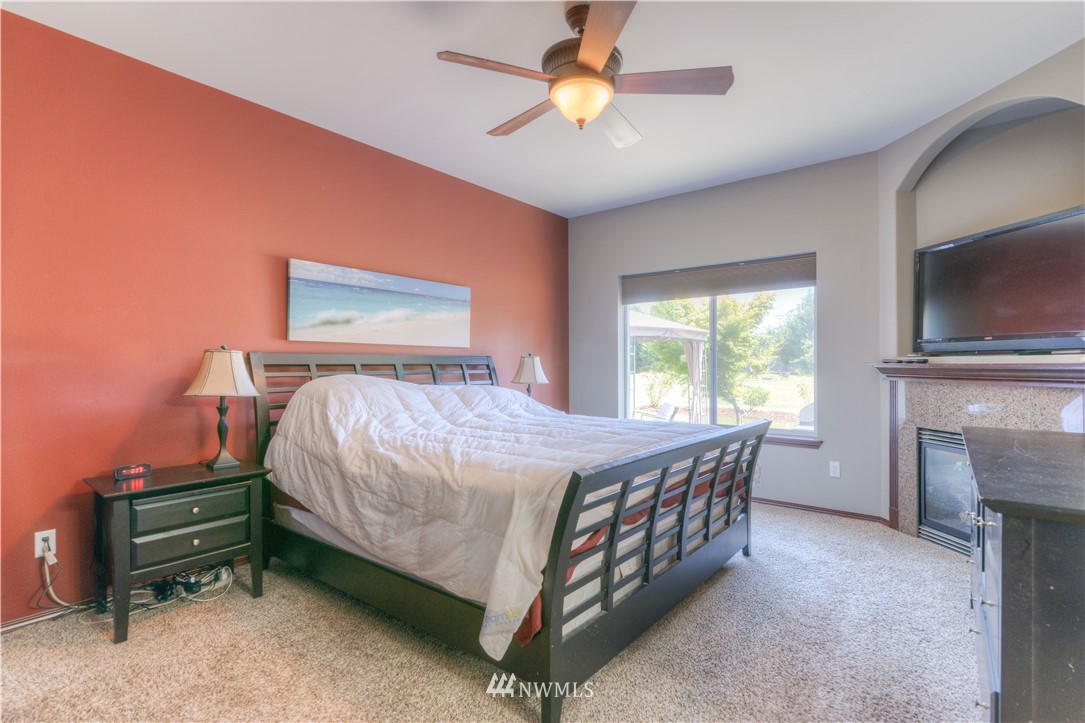 8422 180th Way Southwest Rochester, WA 98579 - Photo 22 of 34 a bedroom with a bed and a flat screen tv