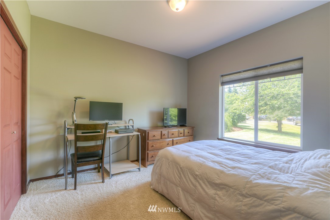 8422 180th Way Southwest Rochester, WA 98579 - Photo 27 of 34 a bedroom with a bed and a flat screen tv