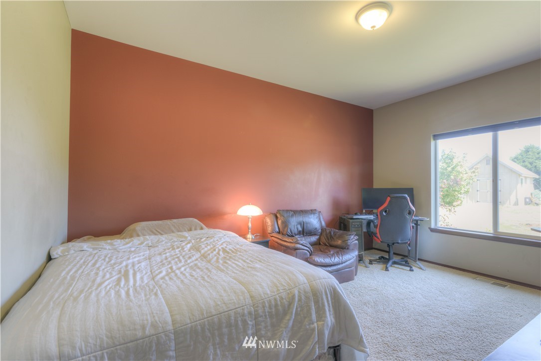 8422 180th Way Southwest Rochester, WA 98579 - Photo 28 of 34 a bed sitting in a room next to a window
