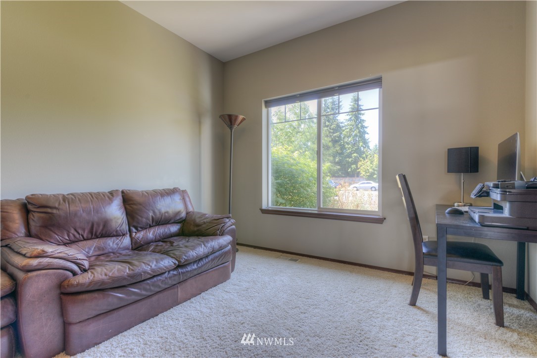 8422 180th Way Southwest Rochester, WA 98579 - Photo 29 of 34 a living room with furniture and a flat screen tv