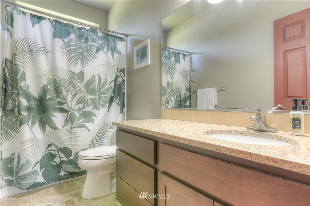 8422 180th Way Southwest Rochester, WA 98579 - Photo 30 of 34 a bathroom with a granite countertop sink and a mirror