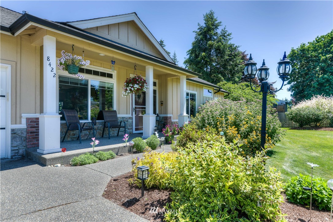 8422 180th Way Southwest Rochester, WA 98579 - Photo 4 of 34 a front view of a house with garden