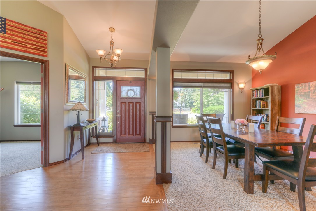 8422 180th Way Southwest Rochester, WA 98579 - Photo 7 of 34 a view of a a dining room with furniture window and wooden floor