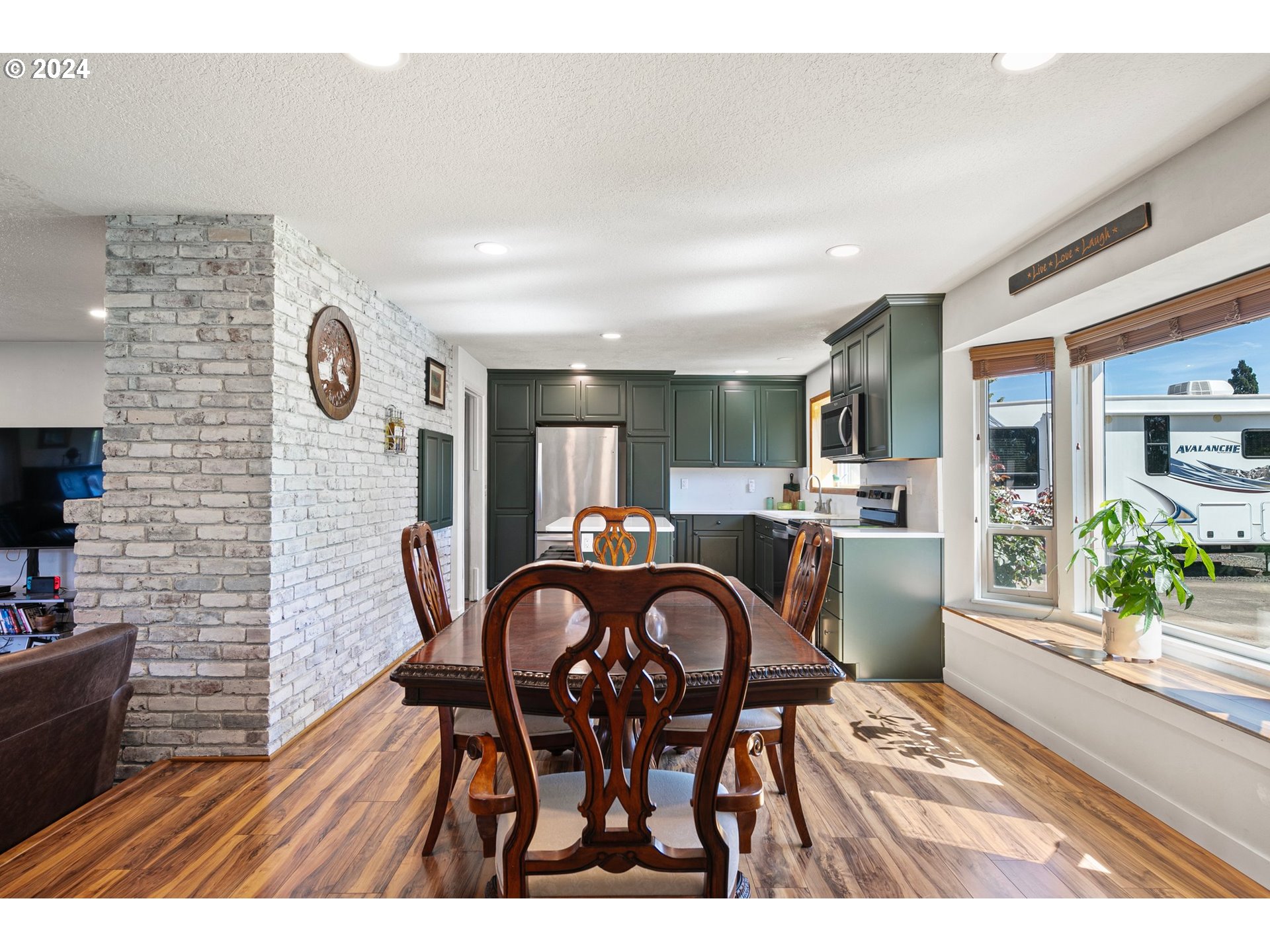 390 Cambridge Street Springfield, OR 97477 - Photo 12 of 48 a view of a dining room with furniture and wooden floor