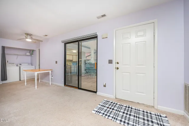 a view of a hallway with wooden floor and a cabinet