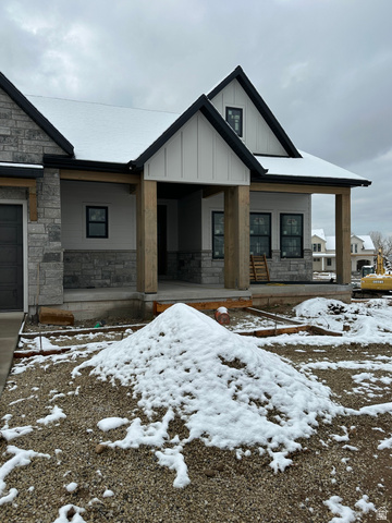 143 South Chamberlain Street, Unit 327 Mapleton, UT 84664 - Photo 2 of 12 View of front of home with stone siding, board and batten siding, and covered porch