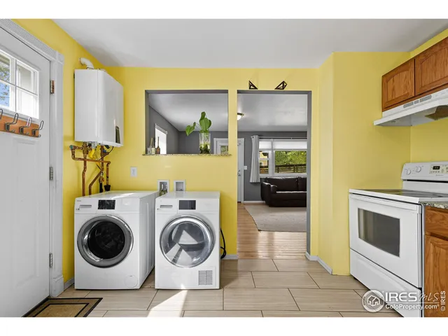 a utility room with sink dryer and washer