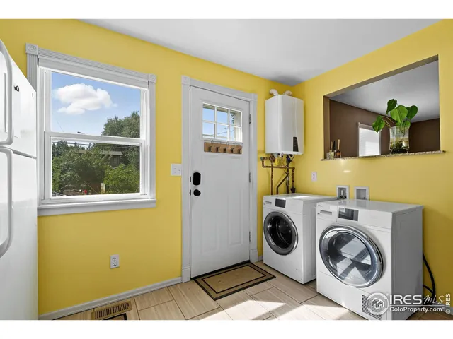 a utility room with window dryer and washer