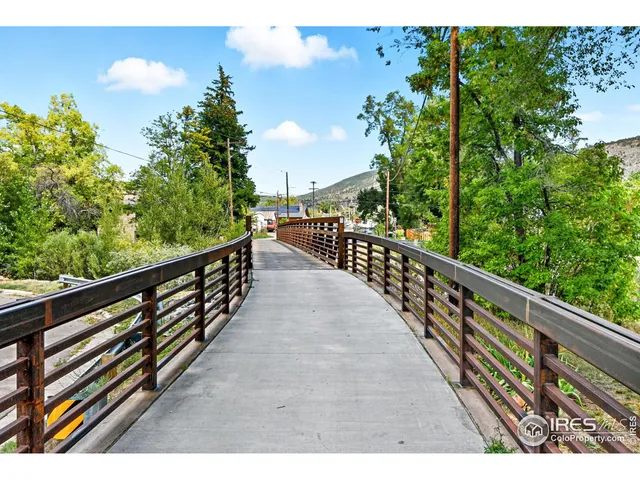 a view of balcony with wooden floor and fence