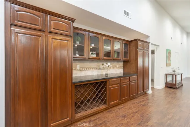 a kitchen with stainless steel appliances granite countertop a refrigerator and wooden cabinets