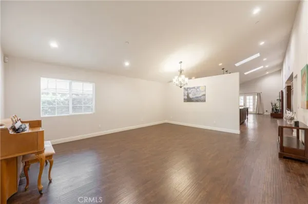 a view of a livingroom with wooden floor and a large window