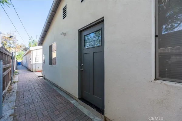 a living room with furniture a flat screen tv and a large window