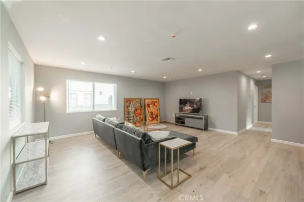 a living room with furniture and kitchen view
