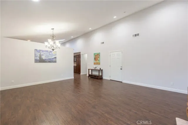 an empty room with wooden floor and furniture