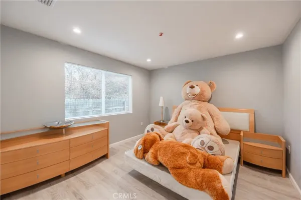 a spacious bedroom with a bed and a walk in closet