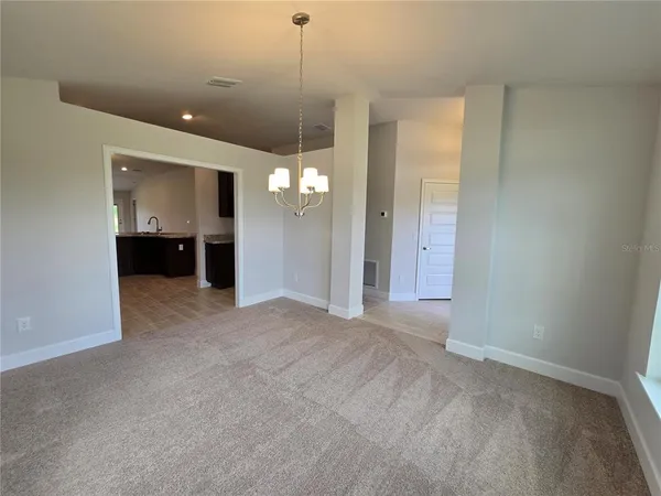 a view of a room with a ceiling fan and window