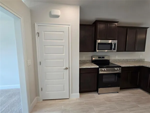 a kitchen with a refrigerator stove and cabinets