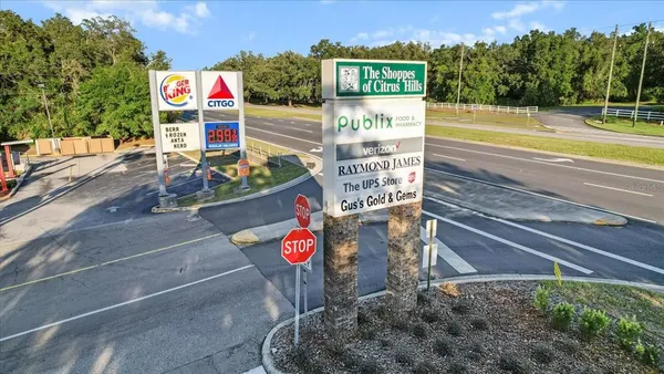 a street sign on a road next to a building