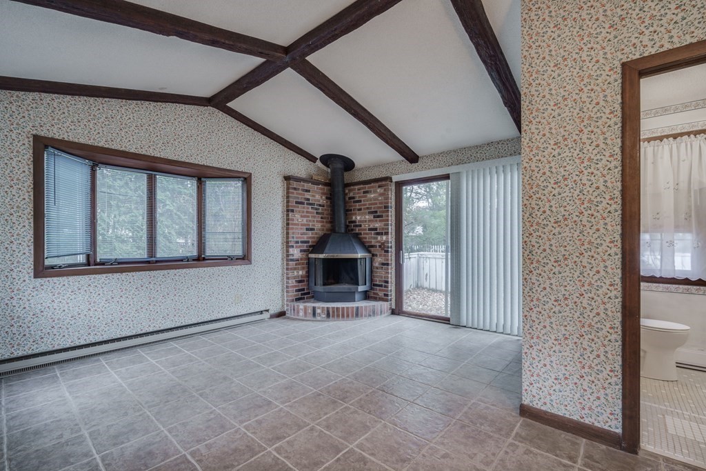 80 Embassy Road Springfield, MA 01119 - Photo 17 of 38 a view of an empty room with a fireplace and windows