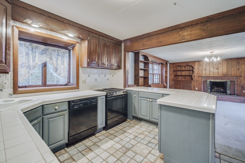 80 Embassy Road Springfield, MA 01119 - Photo 9 of 38 a kitchen with a stove top oven sink and cabinets