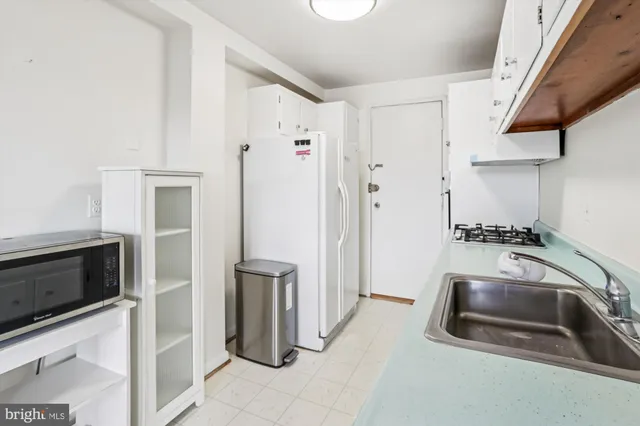 a kitchen with sink cabinets and window