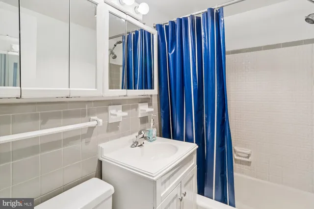 a bathroom with a sink vanity and tub