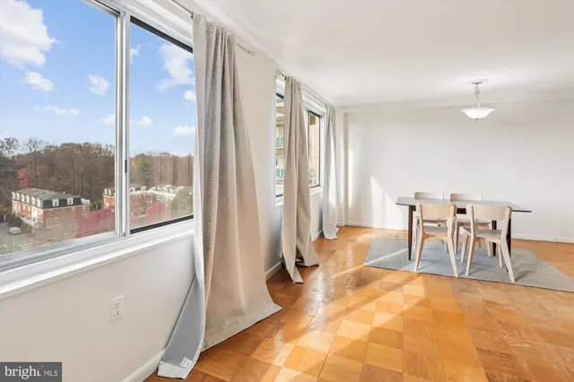 a view of a room with furniture and floor to ceiling window