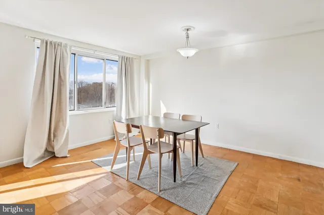 a view of a dining room with furniture and a window