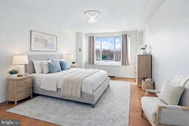 a spacious bedroom with a bed and window