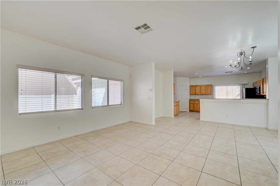 8918 Houston Ridge Avenue Las Vegas, NV 89178 - Photo 4 of 35 A welcoming interior offers light-toned tile flooring and ample natural illumination.