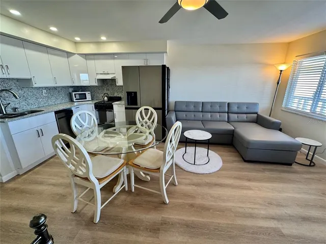 a kitchen with stainless steel appliances granite countertop a refrigerator sink and cabinets