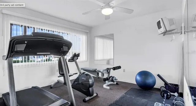 a room with pool table and two windows