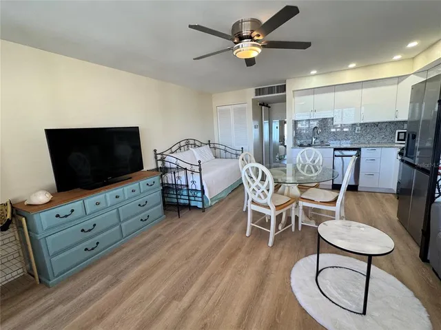 a living room with furniture a ceiling fan and a rug