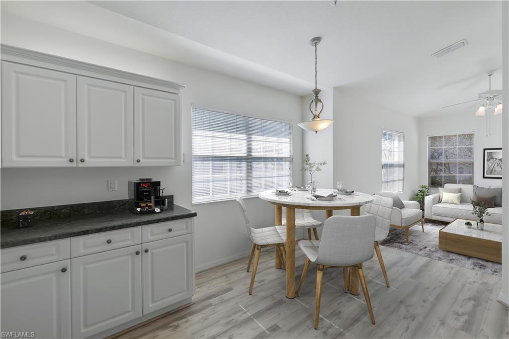 6812 Satinleaf Road South, Unit 204 Naples, FL 34109 - Photo 12 of 39 a kitchen that has a table and chairs in it