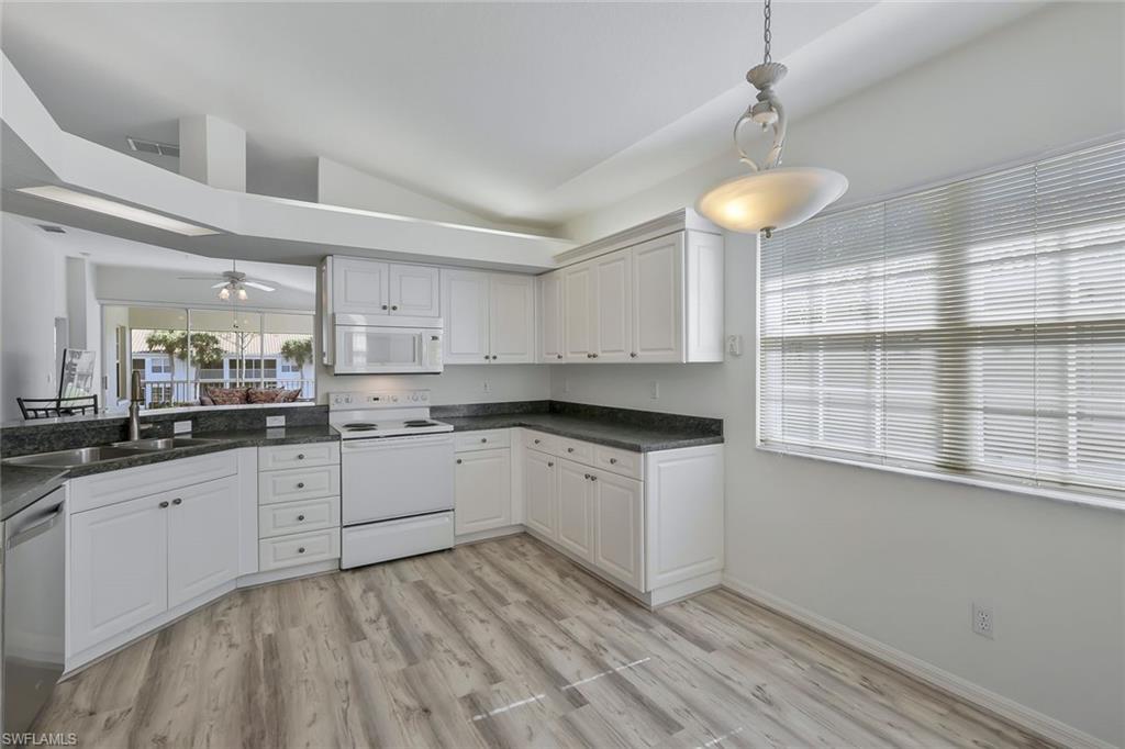 6812 Satinleaf Road South, Unit 204 Naples, FL 34109 - Photo 15 of 39 a kitchen with a sink cabinets and window