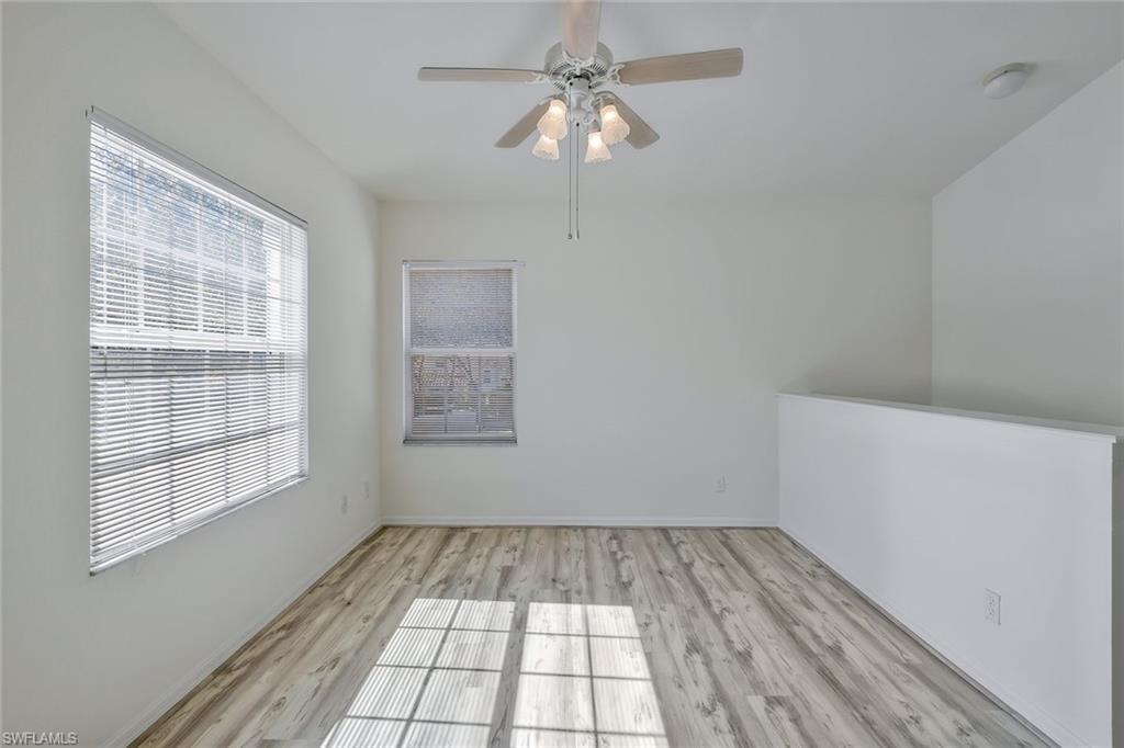 6812 Satinleaf Road South, Unit 204 Naples, FL 34109 - Photo 16 of 39 a view of empty room with wooden floor and fan