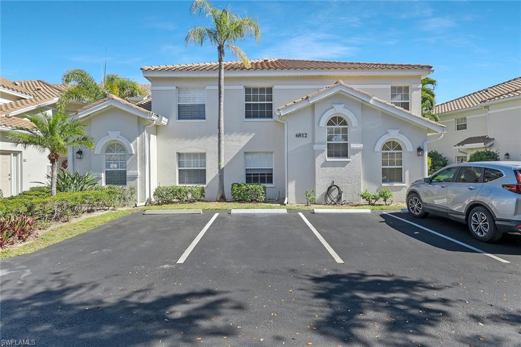 6812 Satinleaf Road South, Unit 204 Naples, FL 34109 - Photo 2 of 39 a front view of a house with a yard